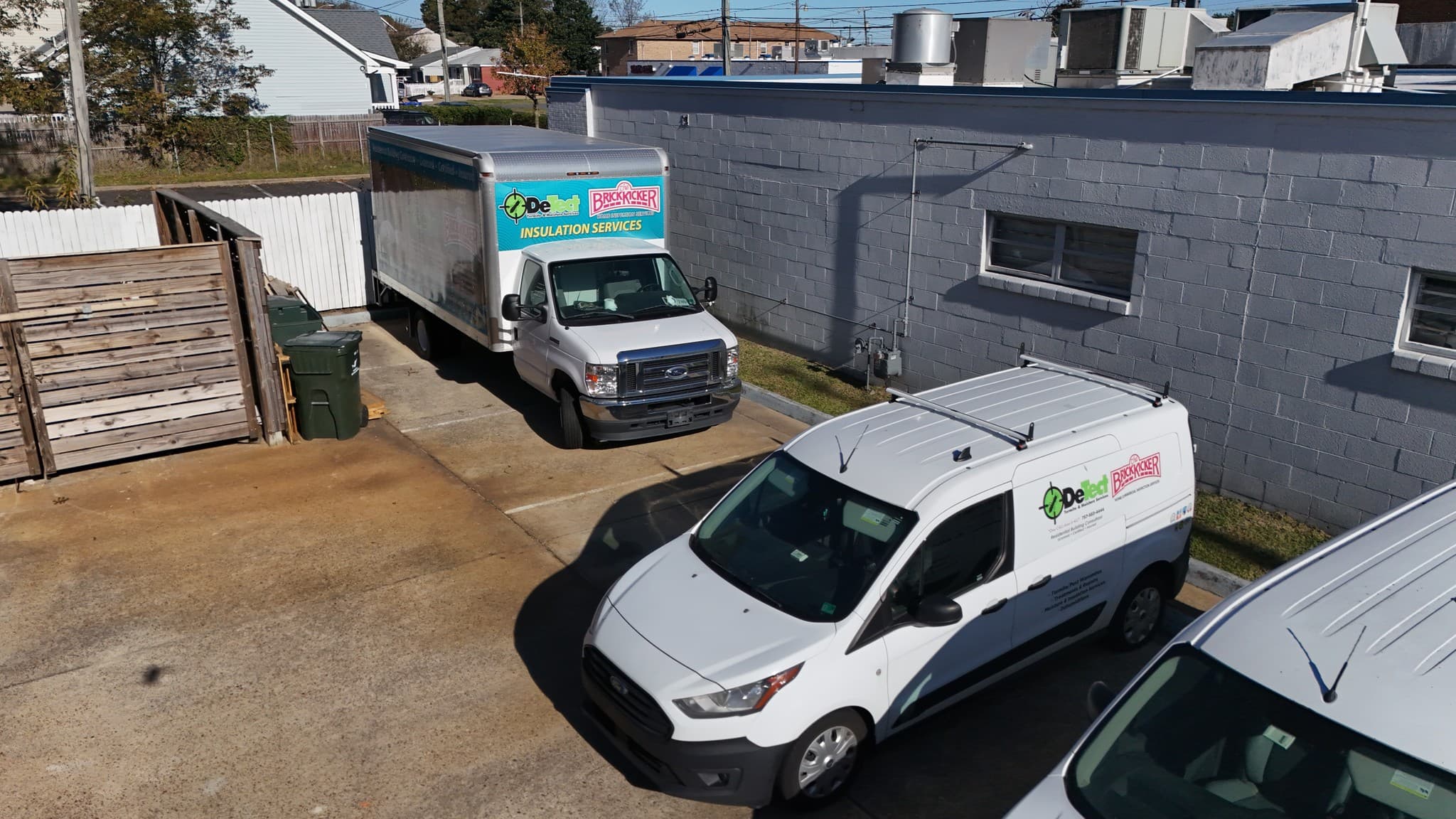 BrickKicker and DeTect Termite & Moisture Services vehicles parked at the company's Norfolk office.